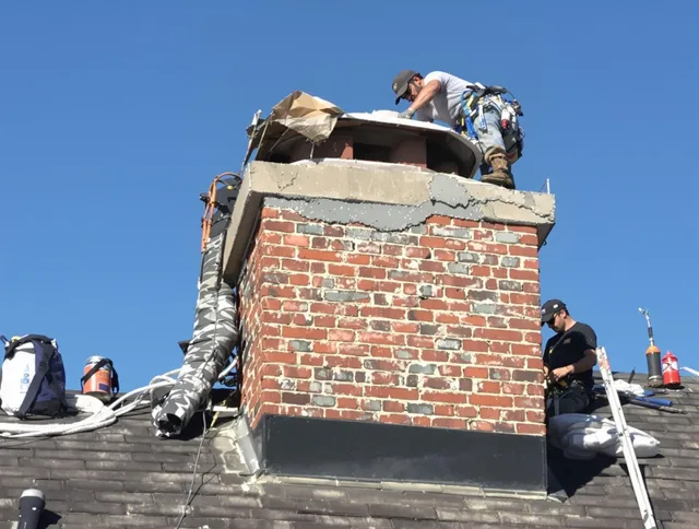 Kendale Lakes Chimney Sweep installing a custom chimney crown in Kendale Lakes, FL